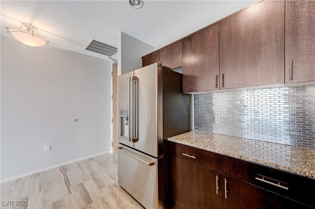 8255 S Las Vegas Blvd Unit 1816, Las Vegas, NV 89123 - kitchen featuring high end refrigerator, backsplash, light stone counters, dark brown cabinetry, and baseboards