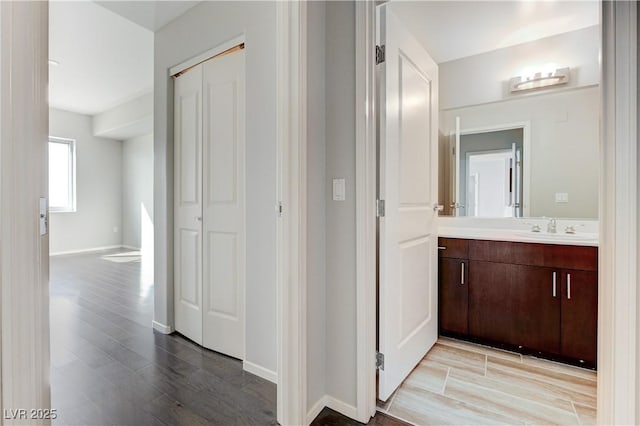 8255 S Las Vegas Blvd Unit 1816, Las Vegas, NV 89123 - corridor featuring a sink, wood finished floors, and baseboards