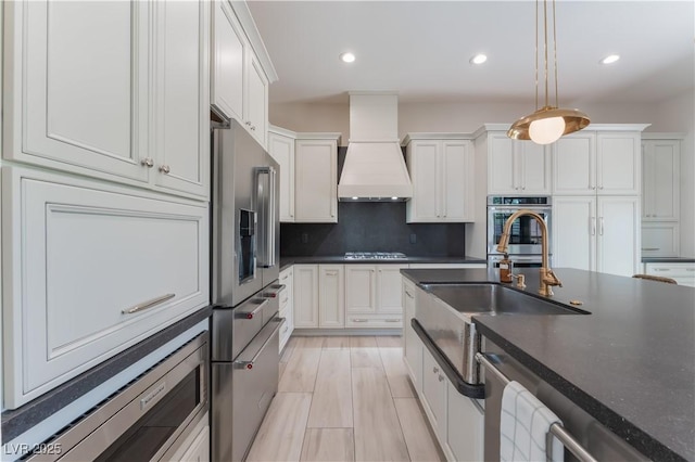 8504 Mystic Night Ave, Las Vegas, NV 89143 - kitchen featuring appliances with stainless steel finishes, custom exhaust hood, dark countertops, white cabinets, and decorative light fixtures