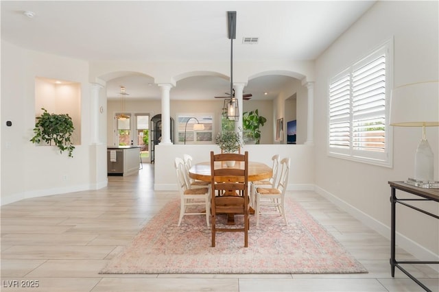 8504 Mystic Night Ave, Las Vegas, NV 89143 - dining room with decorative columns, a ceiling fan, arched walkways, and baseboards