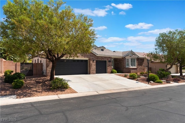 8504 Mystic Night Ave, Las Vegas, NV 89143 - view of front of property featuring a garage, concrete driveway, a tiled roof, and a gate