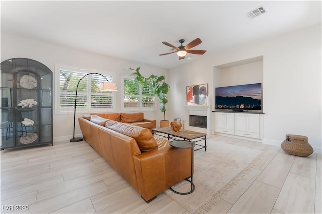 8504 Mystic Night Ave, Las Vegas, NV 89143 - living area with ceiling fan, baseboards, light wood-type flooring, and a fireplace