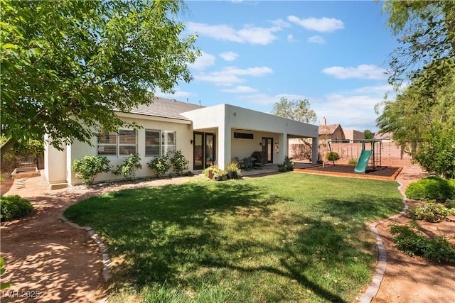 8504 Mystic Night Ave, Las Vegas, NV 89143 - back of house featuring a playground, stucco siding, and a patio