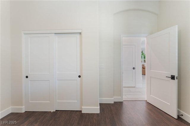8504 Mystic Night Ave, Las Vegas, NV 89143 - unfurnished bedroom featuring baseboards, dark wood finished floors, and a closet