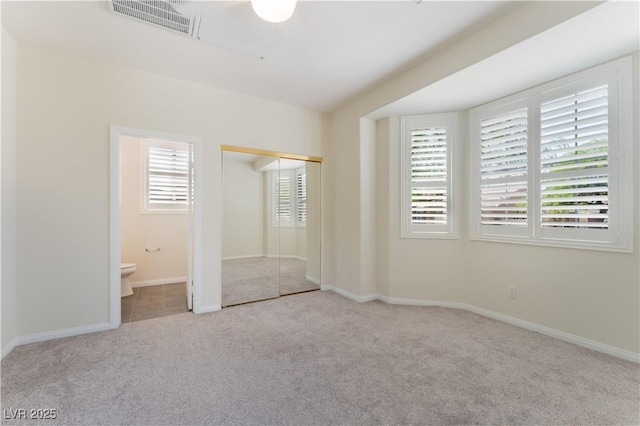8504 Mystic Night Ave, Las Vegas, NV 89143 - unfurnished bedroom featuring carpet flooring, connected bathroom, baseboards, and a closet