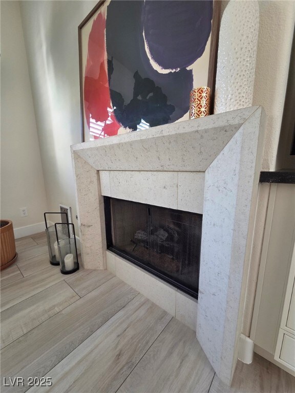 8504 Mystic Night Ave, Las Vegas, NV 89143 - detailed view of a fireplace, wood finished floors, and baseboards