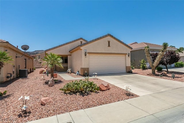 1793 Eagle Village Ave, Henderson, NV 89012 - view of front facade featuring an attached garage, central AC, stucco siding, and concrete driveway