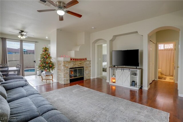 10605 Moon Flower Arbor Pl, Las Vegas, NV 89144 - living room with arched walkways, ceiling fan, plenty of natural light, and wood finished floors