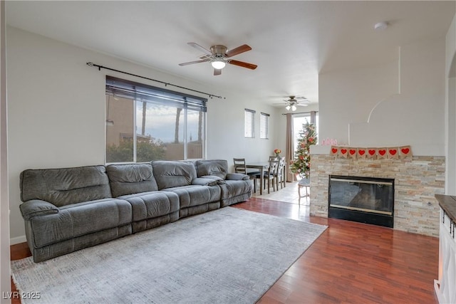 10605 Moon Flower Arbor Pl, Las Vegas, NV 89144 - living room featuring a ceiling fan, wood finished floors, and a stone fireplace
