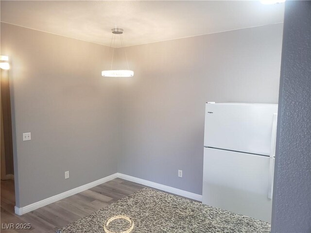 5655 E Sahara Ave Unit 2068, Las Vegas, NV 89142 - unfurnished dining area featuring wood finished floors and baseboards