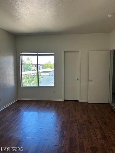9000 Las Vegas Blvd Unit 2189, Las Vegas, NV 89123 - unfurnished bedroom featuring dark wood-style flooring, baseboards, and a textured ceiling