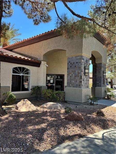 9000 Las Vegas Blvd Unit 2189, Las Vegas, NV 89123 - view of exterior entry with stucco siding, stone siding, and a tile roof