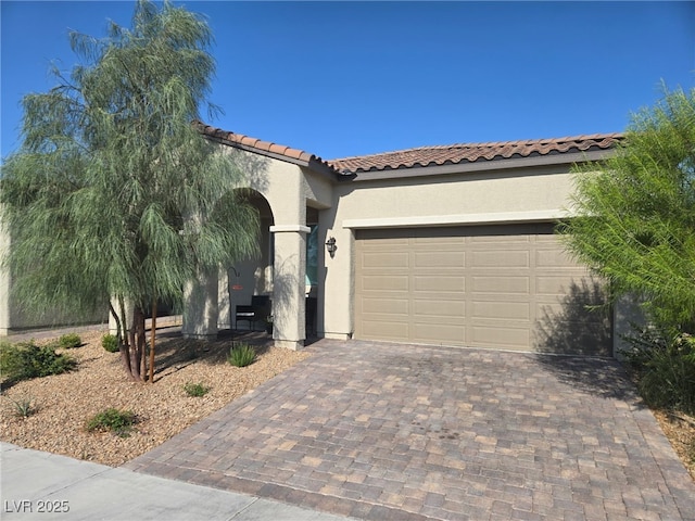 4719 N Transcendental St, North Las Vegas, NV 89031 - mediterranean / spanish-style home featuring stucco siding, decorative driveway, a tiled roof, and an attached garage