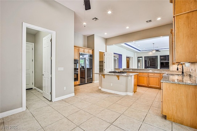 213 Villa Borghese St, Las Vegas, NV 89138 - kitchen featuring a sink, high end refrigerator, light stone countertops, a ceiling fan, and light tile patterned floors