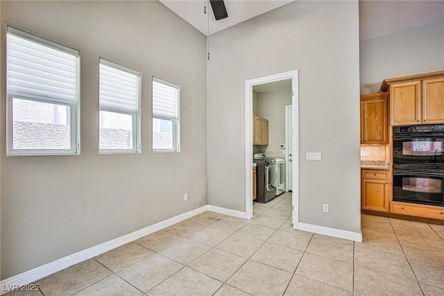 213 Villa Borghese St, Las Vegas, NV 89138 - kitchen featuring washer and clothes dryer, light tile patterned floors, ceiling fan, baseboards, and decorative backsplash