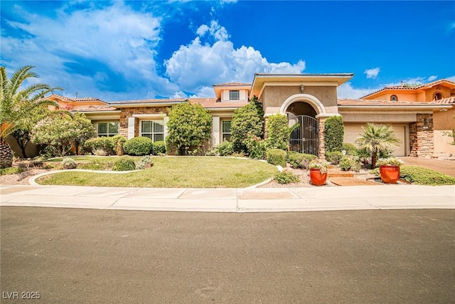 213 Villa Borghese St, Las Vegas, NV 89138 - mediterranean / spanish-style house with an attached garage, stone siding, stucco siding, and driveway