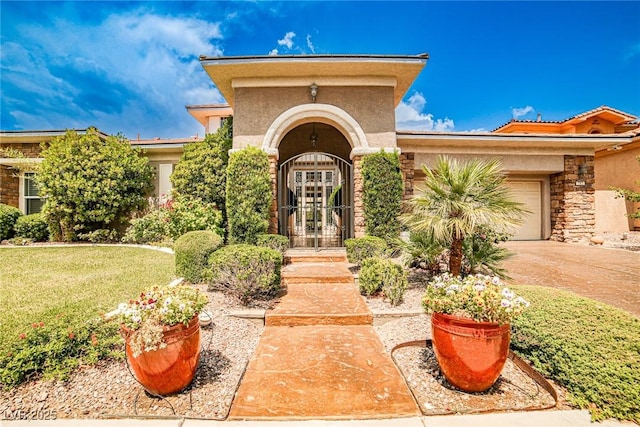213 Villa Borghese St, Las Vegas, NV 89138 - view of front of house with stucco siding, a garage, stone siding, driveway, and a front yard