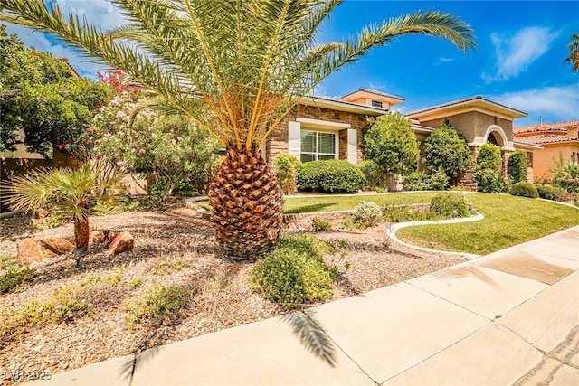 213 Villa Borghese St, Las Vegas, NV 89138 - obstructed view of property with a front lawn and stone siding