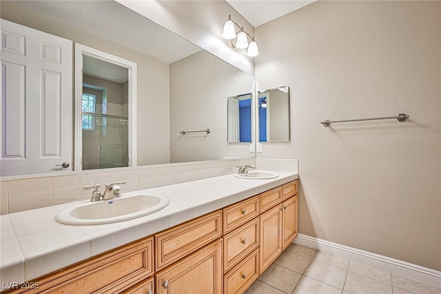 213 Villa Borghese St, Las Vegas, NV 89138 - full bath featuring a shower stall, double vanity, baseboards, and tile patterned flooring