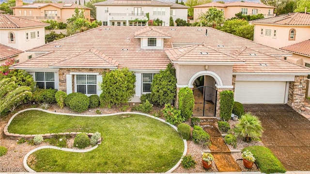 213 Villa Borghese St, Las Vegas, NV 89138 - mediterranean / spanish-style home featuring a tile roof, a residential view, asphalt driveway, and stone siding