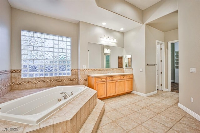 213 Villa Borghese St, Las Vegas, NV 89138 - bathroom with vanity, a tub with jets, tile patterned floors, baseboards, and recessed lighting