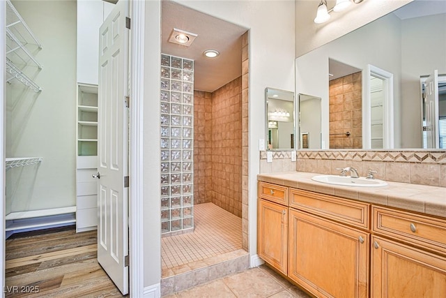 213 Villa Borghese St, Las Vegas, NV 89138 - bathroom featuring walk in shower, vanity, a walk in closet, and backsplash