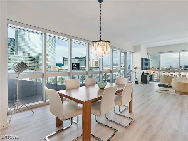 4471 Dean Martin Dr Unit 1109, Las Vegas, NV 89103 - dining area with a chandelier and light wood-style flooring
