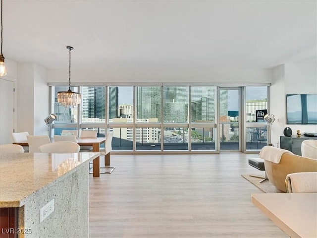 4471 Dean Martin Dr Unit 1109, Las Vegas, NV 89103 - living area with light wood-style flooring and a chandelier