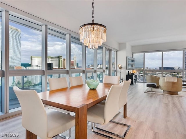 4471 Dean Martin Dr Unit 1109, Las Vegas, NV 89103 - dining area with a chandelier and light wood-style floors