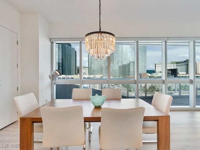 4471 Dean Martin Dr Unit 1109, Las Vegas, NV 89103 - dining room featuring a chandelier and light wood-style flooring
