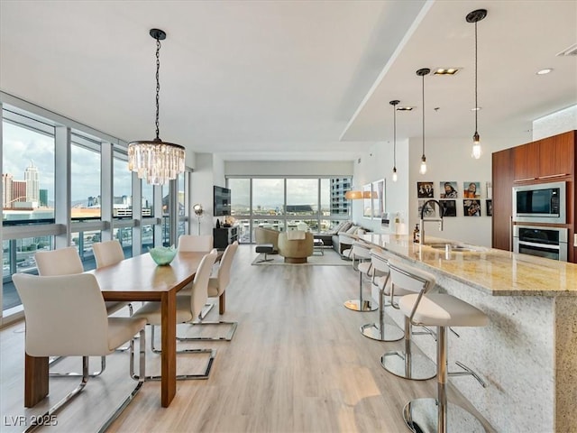 4471 Dean Martin Dr Unit 1109, Las Vegas, NV 89103 - dining room with light wood-style flooring and a chandelier