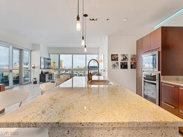 4471 Dean Martin Dr Unit 1109, Las Vegas, NV 89103 - kitchen with stainless steel appliances, a sink, open floor plan, a spacious island, and modern cabinets