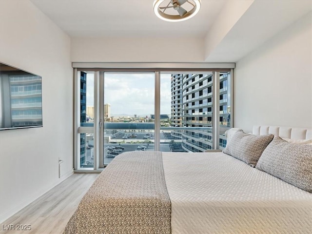 4471 Dean Martin Dr Unit 1109, Las Vegas, NV 89103 - bedroom featuring access to exterior, wood finished floors, and baseboards