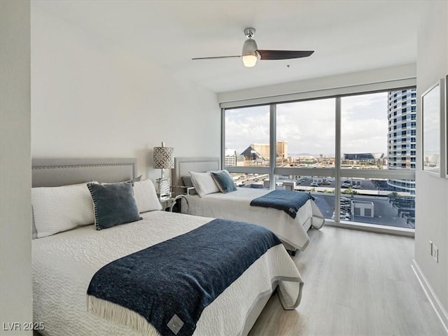 4471 Dean Martin Dr Unit 1109, Las Vegas, NV 89103 - bedroom featuring wood finished floors, access to outside, a view of city, and ceiling fan
