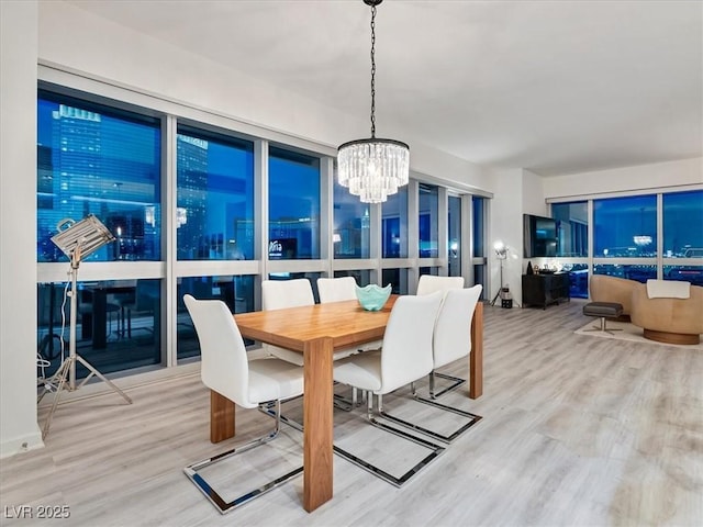 4471 Dean Martin Dr Unit 1109, Las Vegas, NV 89103 - dining room featuring a chandelier and wood finished floors