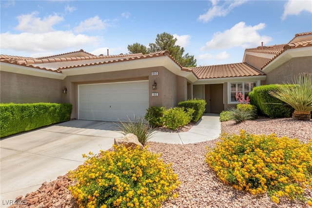 1912 Summer Pine Ct Unit 102, Las Vegas, NV 89134 - view of front of property with an attached garage, stucco siding, driveway, and a tiled roof