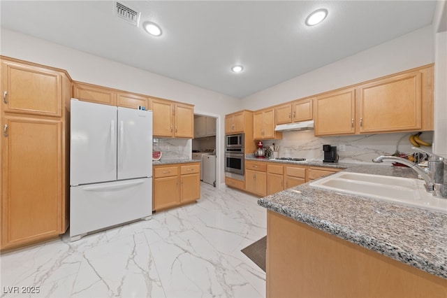 1912 Summer Pine Ct Unit 102, Las Vegas, NV 89134 - kitchen with stainless steel appliances, a sink, light marble finish flooring, light stone countertops, and under cabinet range hood