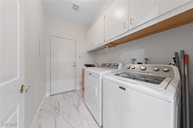 1912 Summer Pine Ct Unit 102, Las Vegas, NV 89134 - laundry room with cabinet space, light marble finish flooring, washing machine and clothes dryer, and baseboards