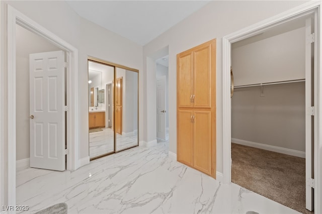 1912 Summer Pine Ct Unit 102, Las Vegas, NV 89134 - unfurnished bedroom with light marble finish flooring, a closet, baseboards, and a spacious closet