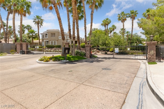1912 Summer Pine Ct Unit 102, Las Vegas, NV 89134 - view of road with a gate, a gated entry, curbs, and street lighting