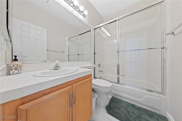1912 Summer Pine Ct Unit 102, Las Vegas, NV 89134 - bathroom featuring toilet, vanity, and combined bath / shower with glass door