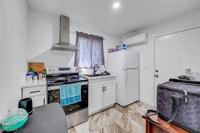 872 N Linn Ln, Las Vegas, NV 89110 - kitchen featuring stainless steel electric range oven, wall chimney exhaust hood, freestanding refrigerator, a wall mounted air conditioner, and white cabinetry