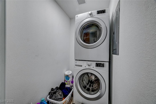 872 N Linn Ln, Las Vegas, NV 89110 - laundry room with estacked washer and dryer and a textured wall