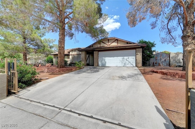 872 N Linn Ln, Las Vegas, NV 89110 - ranch-style house featuring driveway, brick siding, an attached garage, and a gate