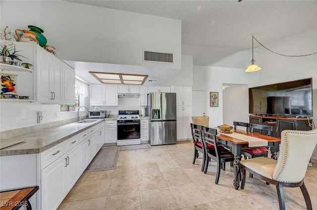 872 N Linn Ln, Las Vegas, NV 89110 - kitchen with stainless steel fridge with ice dispenser, white range with gas stovetop, open shelves, a sink, and white cabinetry