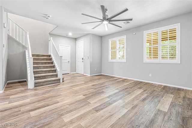 3188 Via Da Vinci, Henderson, NV 89044 - unfurnished living room with light wood finished floors, plenty of natural light, and a ceiling fan