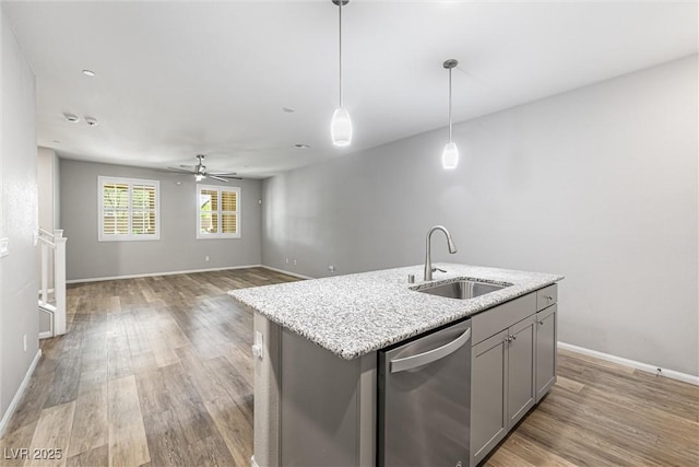 3188 Via Da Vinci, Henderson, NV 89044 - kitchen with stainless steel dishwasher, a sink, gray cabinets, light wood-style floors, and ceiling fan