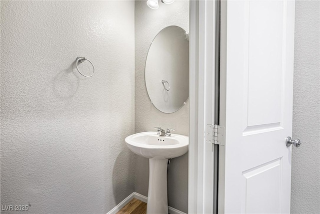 3188 Via Da Vinci, Henderson, NV 89044 - bathroom with wood finished floors, a sink, and a textured wall