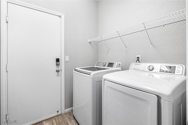 3188 Via Da Vinci, Henderson, NV 89044 - laundry room with washer and dryer, light wood-style flooring, and baseboards