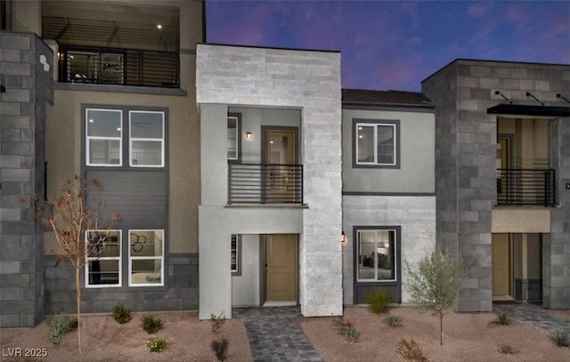 871 Apatite Pl Lot 54, Henderson, NV 89011 - modern home with a balcony, stucco siding, and stone siding